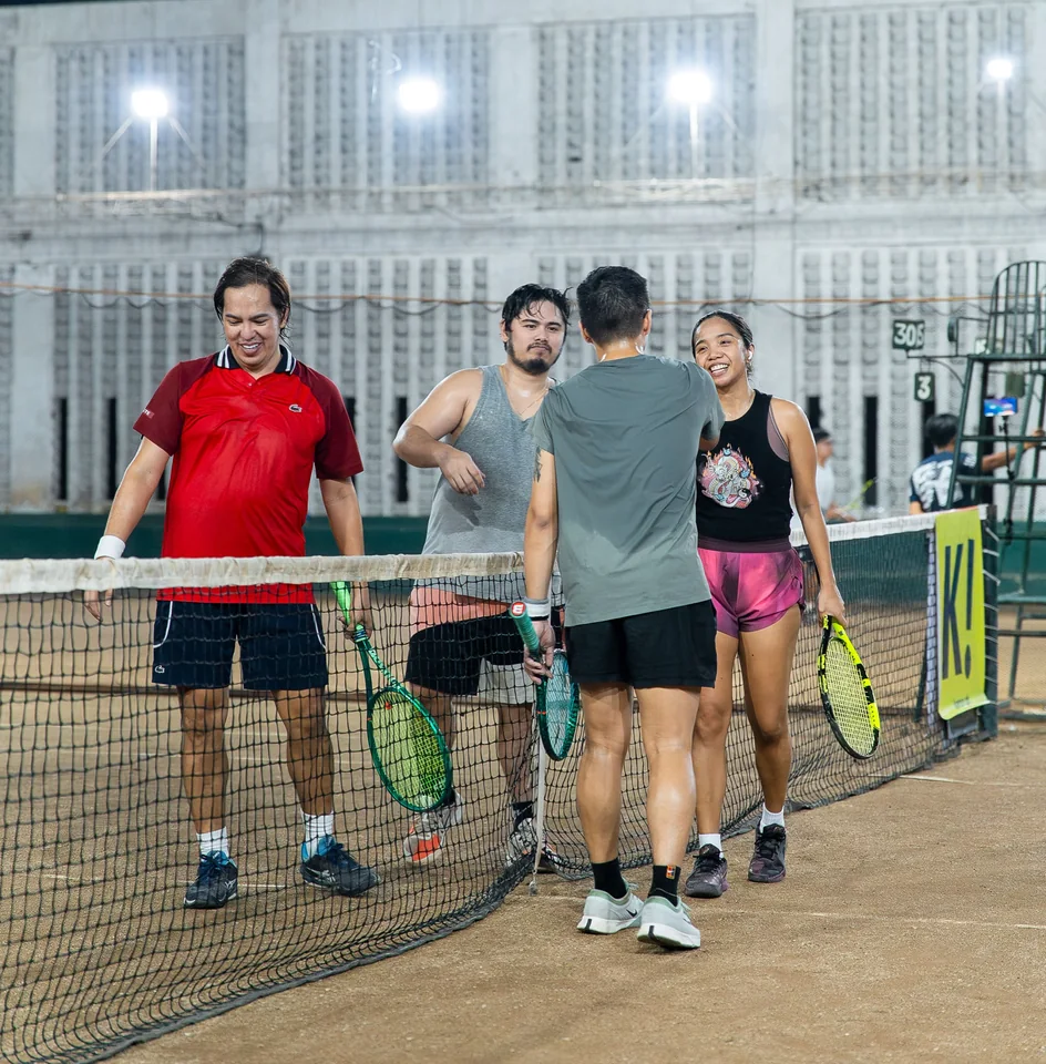 Players meeting at the net after a doubles match