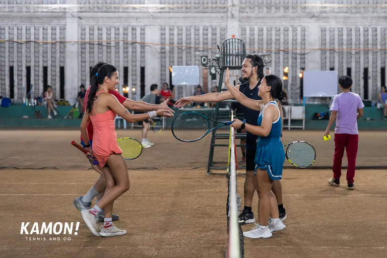 Players celebrating at the net after a doubles match
